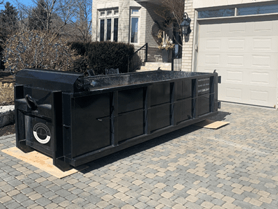 Bin Yard on driveway - mini bin rental Toronto